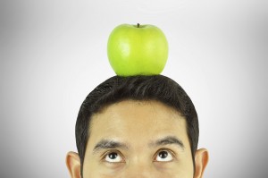 A man thinking with apple on the head