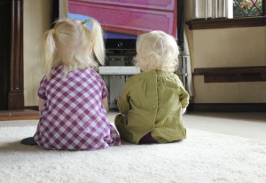 children watching television together
